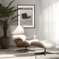 Modern lounge chair with ottoman in a room with a Bauhaus poster on the wall.