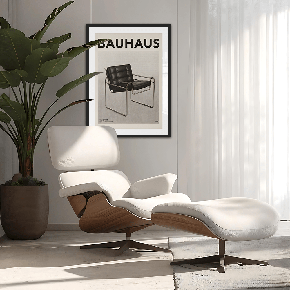 Modern lounge chair with ottoman in a room with a Bauhaus poster on the wall.